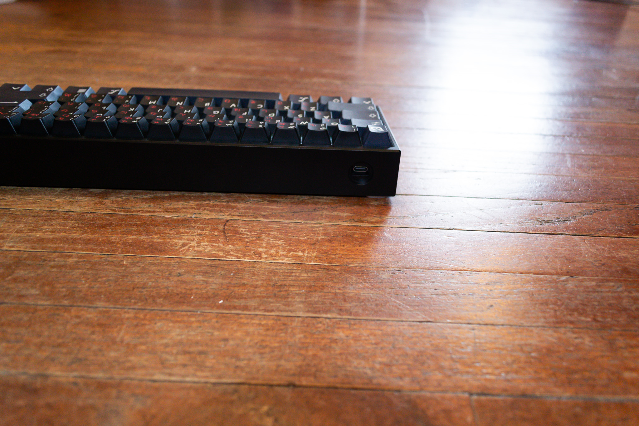 Custom Wooting 60HE back view on Wood Floor 